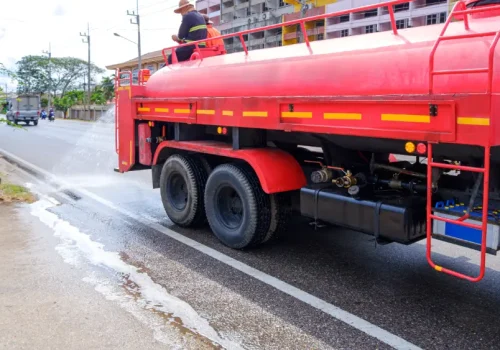 worker-on-fire-truck-spraying-water-on-the-road-fo-2025-06-30-23-33-44-utc(3)